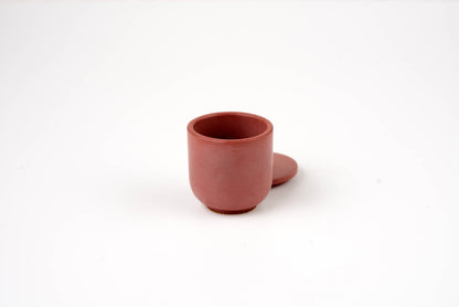 A small Antique Rose Candle Vessel in reddish-brown, with a matching round lid beside it, displayed against a plain white background.